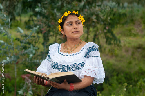 Φωτογραφία Indigenous woman wearing traditional clothes reading a book in nature