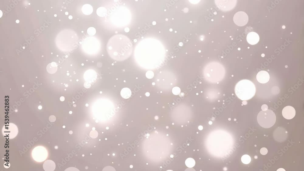 Elegant white bokeh particles floating in a soft diffused light background for a magical or dreamy effect creating a festive or celebratory mood.