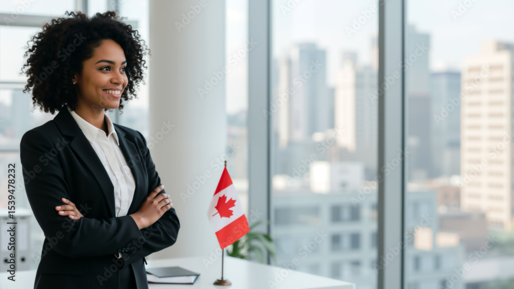 Fototapeta premium Smiling Black businesswoman in an office with a Canadian flag. Success and diversity in Canadian business.
