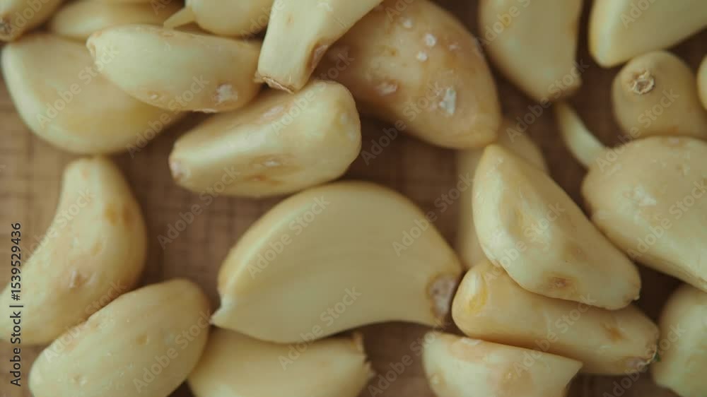 Garlic cloves prepared for cooking in a kitchen setting Garlic cloves prepared for cooking in a kitchen setting