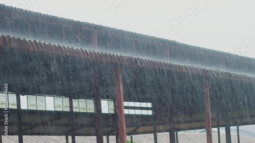 A heavy rain or raindrop falling hit on the market structure roof, weather forecast and rain season, 4K high quality video footage