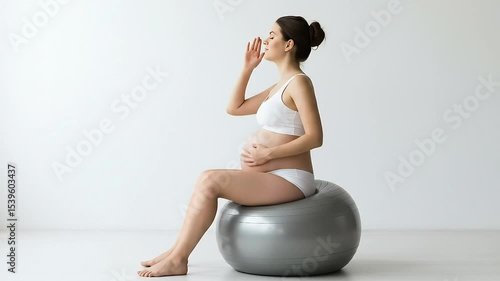pregnant woman holding belly and smiling
