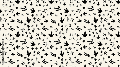 Fototapeta Naklejka Na Ścianę i Meble -  Seamless pattern of black dinosaur footprints on a white background in a repeating design style