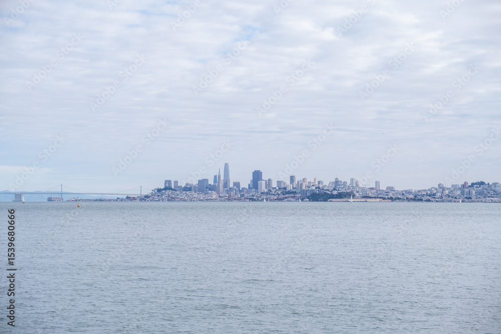 Naklejka premium Panoramic view of San Francisco skyline from across the water under a soft cloudy sky, Marin County, CA, January 30, 2021