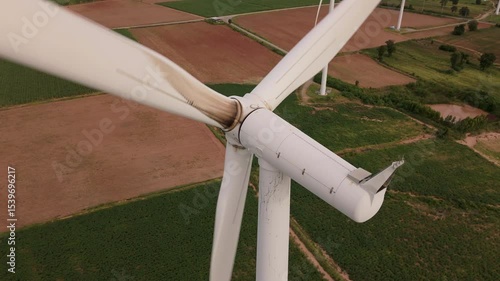 Detailed drone view of a wind turbine with visible oil stains and wear marks on the hub and tower, highlighting the need for technical maintenance and inspection.