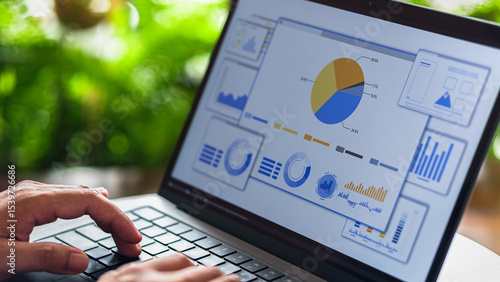 Photos Business analyst reviewing digital charts and data on interactive performance dashboard