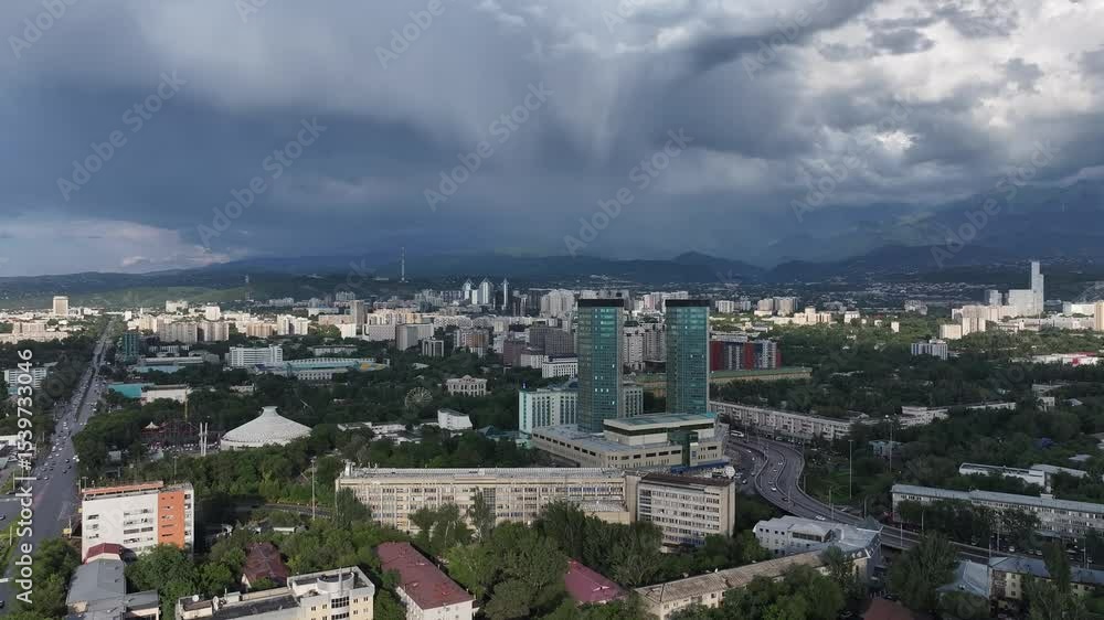 View from a quadcopter of the central part of the Kazakh city of Almaty and thunderclouds over the Zailiyskiy Alatau mountains View from a quadcopter of the central part of the Kazakh city of Almaty and thunderclouds over the Zailiyskiy Alatau mountains
