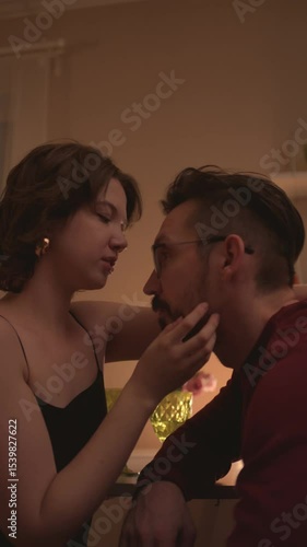 oung couple enjoying a romantic evening at home — soft lights, laughter, cozy conversation, and deep connection. Warm atmosphere of love, intimacy, and shared moments in the living room