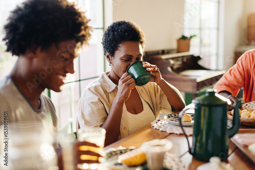 Brazilian family enjoying a homemade breakfast, sipping on café coado