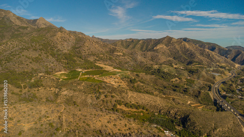 Rugged Hills and Winding Road Near Nerja, Captured by Drone