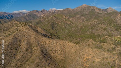 Rugged Hills and Winding Road Near Nerja, Captured by Drone
