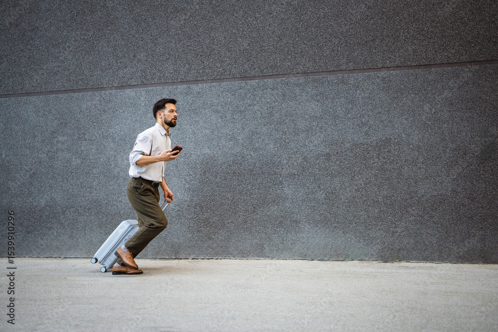 busy passenger businessman run with suitcase in the city and hold phone busy passenger businessman run with suitcase in the city and hold phone