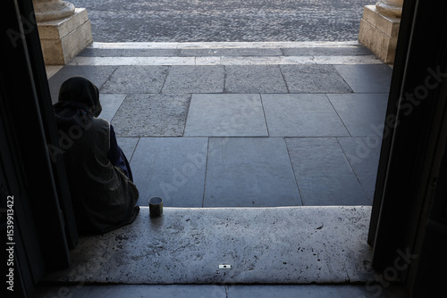 Fotografie Woman begging outside Santa Maria dei miracoli church, Rome, Italy