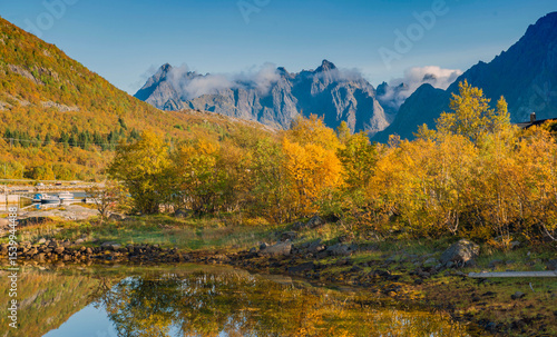 beautiful landscape of Norway with trees with yellow leaves reflecting in the...