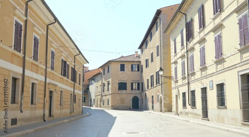 Picturesque European street lined with pastel-colored buildings.