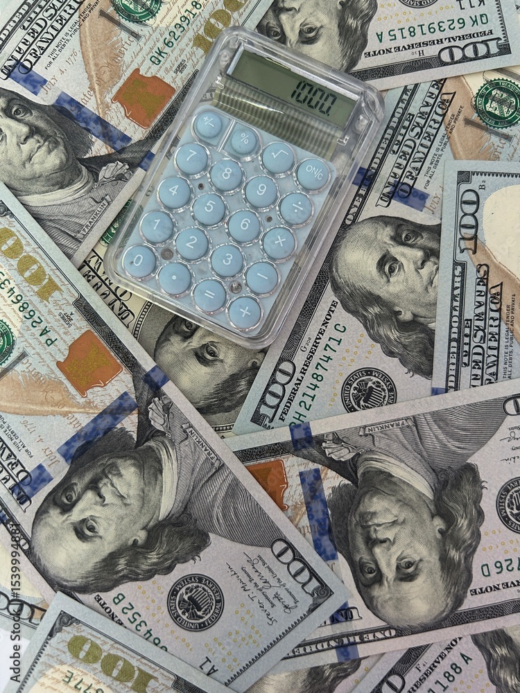 Fototapeta premium Calculator on US dollar bills symbolizing loans debt financial crisis and economic instability