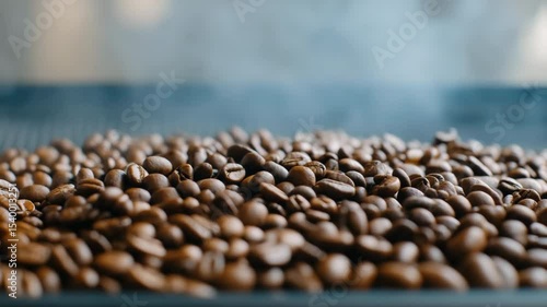 Wallpaper Mural A pile of coffee beans with steam rising from them. The beans are spread out on a black surface, and the steam gives the scene a cozy, warm feeling Torontodigital.ca