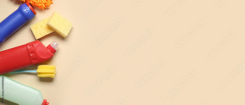 Composition with bottles of detergents and different cleaning supplies on color background