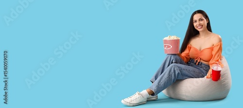 Young woman with popcorn an...