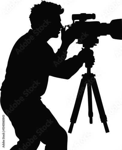 Silhouette of a focused cameraman using a professional video camera on tripod