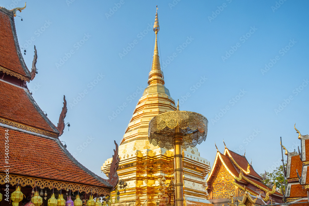 Fototapeta premium Golden stupa at Buddhist temple Wat Phra That Doi Suthep with ornate golden ceremonial umbrella in Chiang Mai, Thailand. Thai religious architecture. Travel and touristic landmark