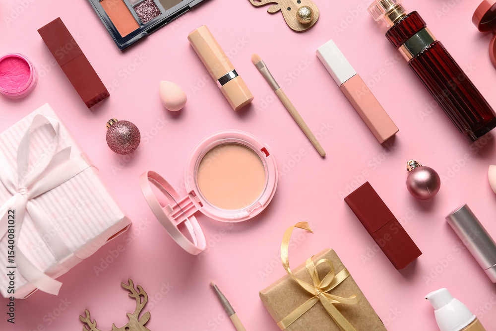 Naklejka premium Christmas composition with different makeup products and gift box on pink background