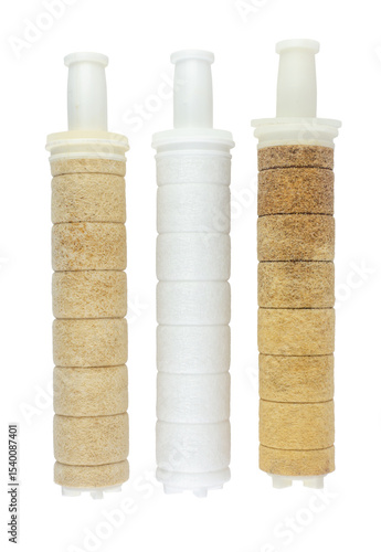 Side-by-side on a transparent background, two heavily soiled and worn water filters are positioned next to a gleaming, new white filter