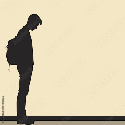 Young man standing with head down   