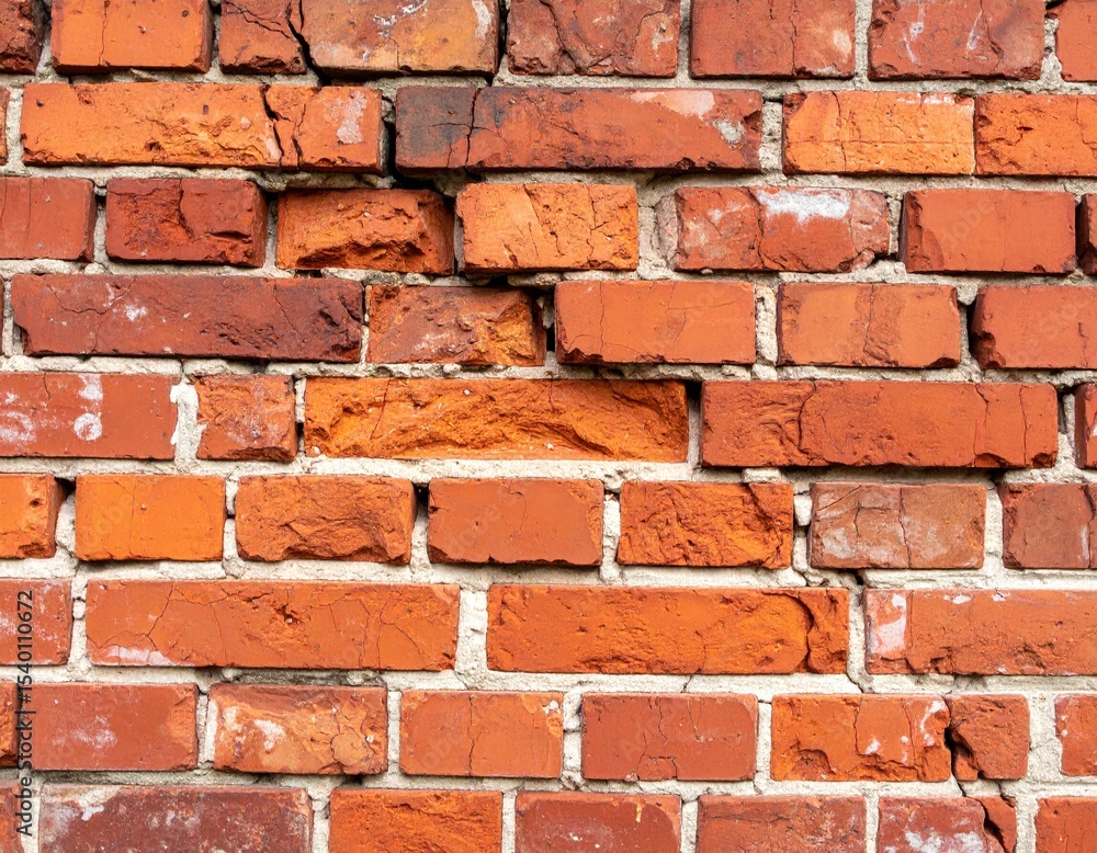 Obraz premium Damaged Red Brick Wall with Cracks