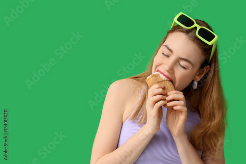 Young woman biting vanilla ...