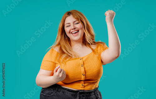 Plus size happy woman with triumph yes victory gesture. Jackpot, win, success