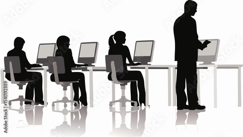Silhouetted figures working at computers in a row with a standing figure overseeing the work area well lit