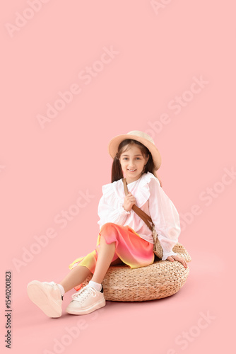 Stylish girl in hat sitting...