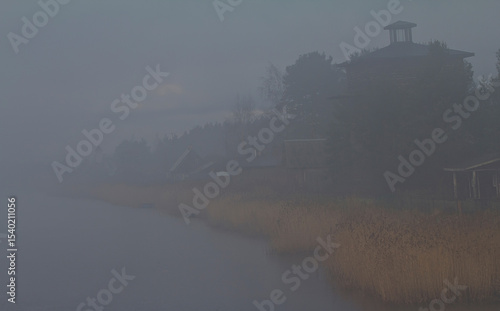 Scotch mist, milky air over the lake village on a spring day