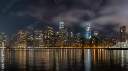 Glowing night skyline reflected over riverfront buildings