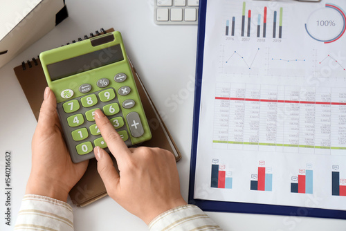 Female accountant with calc...