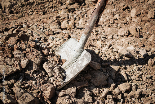 Wallpaper Mural Shovel resting on freshly disturbed soil during construction work in the early morning light Torontodigital.ca
