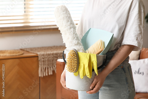Young woman with bucket of ...