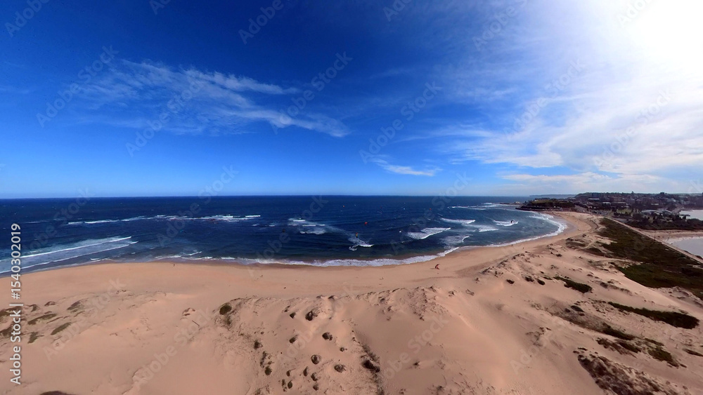 Newcastle Nobbys Beach NSW Australia Aerial View of Coastal Beach and Ocean Under Blue Sky and Rolling Waves Newcastle Nobbys Beach NSW Australia Aerial View of Coastal Beach and Ocean Under Blue Sky and Rolling Waves
