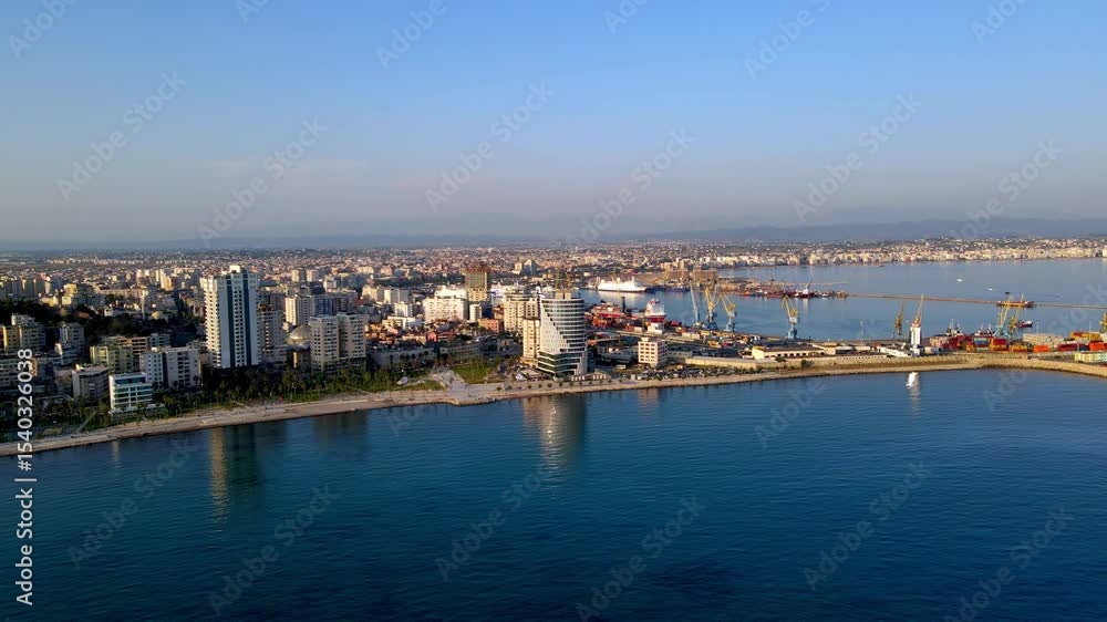 Scenic aerial drone video showing a view from the Adriatic Sea toward the coastline of Durrës, Albania. The footage captures the beachfront, urban skyline, and coastal architecture Scenic aerial drone video showing a view from the Adriatic Sea toward the coastline of Durrës, Albania. The footage captures the beachfront, urban skyline, and coastal architecture