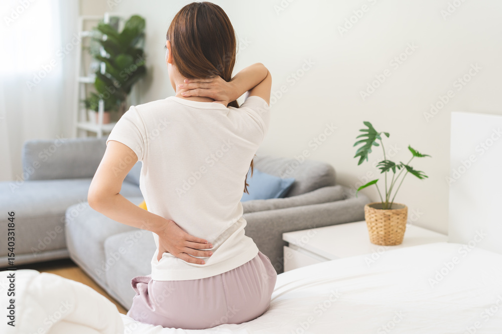 Pain body muscles stiff problem, asian young woman painful with back, neck ache from work hand holding massaging rubbing shoulder hurt, sore sitting on bed in room at home. Health care and medicine. Pain body muscles stiff problem, asian young woman painful with back, neck ache from work hand holding massaging rubbing shoulder hurt, sore sitting on bed in room at home. Health care and medicine.