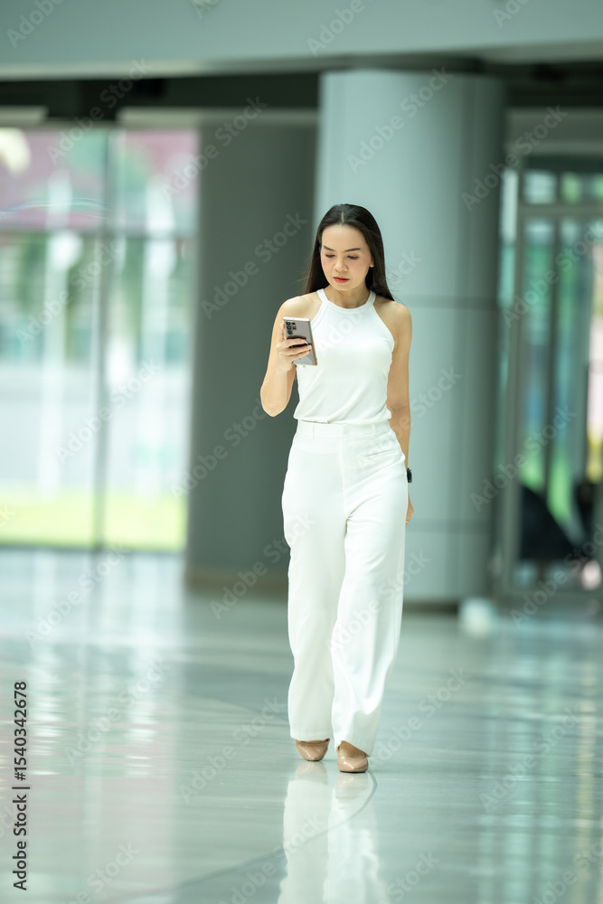 Fototapeta premium She is looking at the screen of the phone
