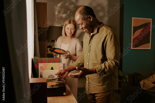 Canvas Print Senior Black man and senior Caucasian woman selecting vinyl records together, sm