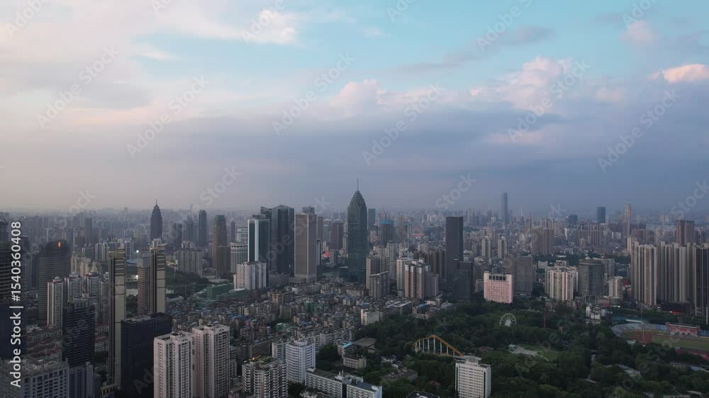 Aerial View of Zhengzhou Cityscape at Dusk, Showing Skyscrapers, Financial District, and Urban Skyline under Blue Sky with Clouds Aerial View of Zhengzhou Cityscape at Dusk, Showing Skyscrapers, Financial District, and Urban Skyline under Blue Sky with Clouds