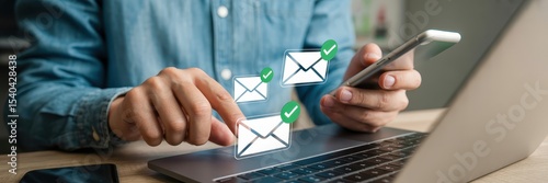 Person interacting with email notifications on laptop and phone.