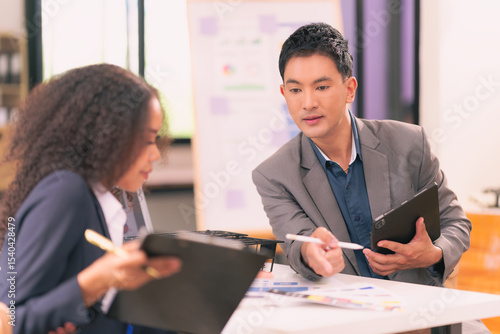 Wallpaper Mural Two businessmen looking at computer screen with many graphs and charts and tablet for statistics, financial reports and planning revenue, profit or sales in office. Torontodigital.ca