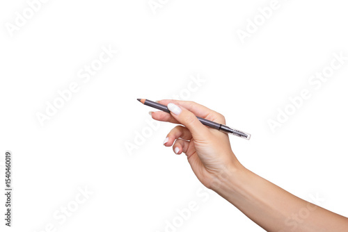Female hand holding eyebrow pencil with brush for shading, isolated on white background. Self-care, beauty, fashion and makeup application concept