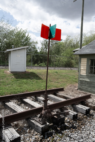 red and green railroad signal post