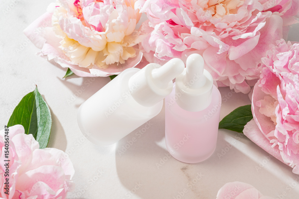 fresh peony flowers background and bottle with cosmetic oil for branding. Wellness, home skin care and spa relax treatment concept. Mockup package fresh peony flowers background and bottle with cosmetic oil for branding. Wellness, home skin care and spa relax treatment concept. Mockup package