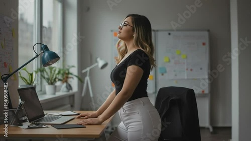 Woman Relaxing with Eyes Closed at Office Desk Taking a Break